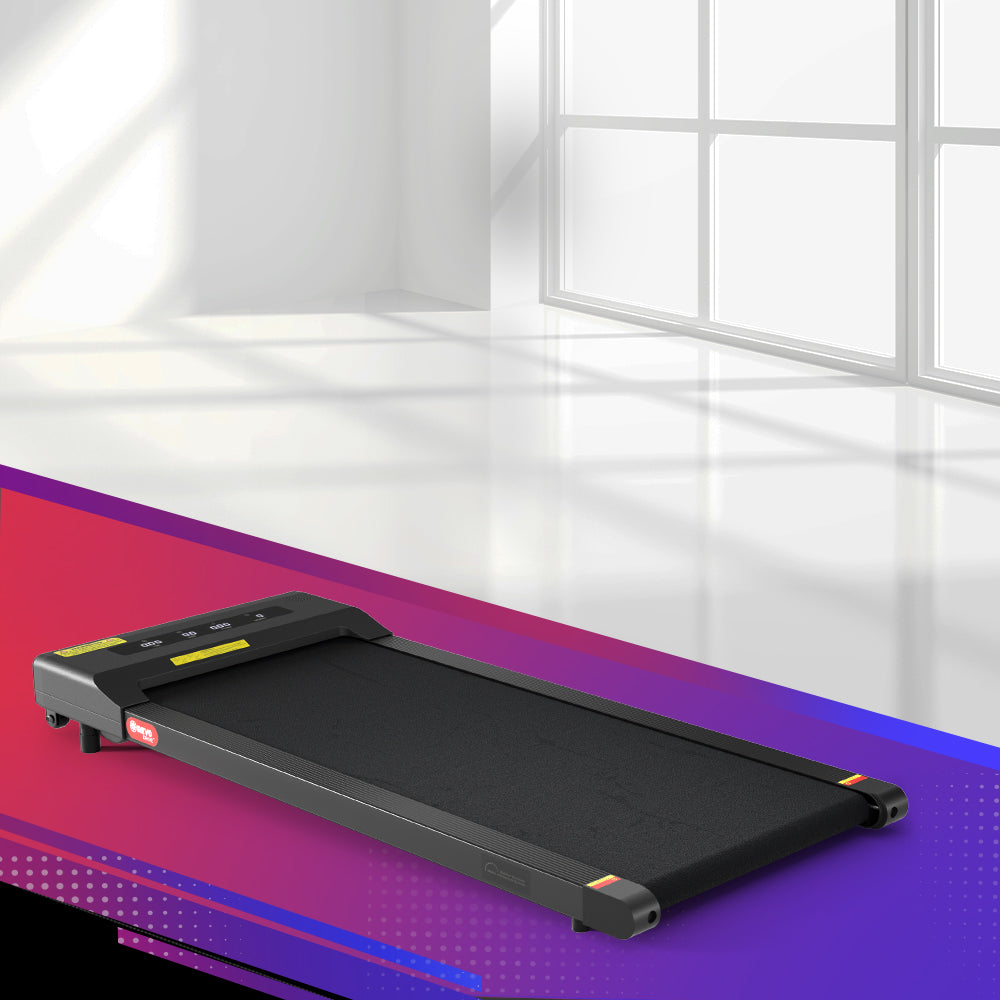 Fitlybuy ultra-slim black electric walking pad treadmill featuring a sleek, space-saving design in a bright studio.