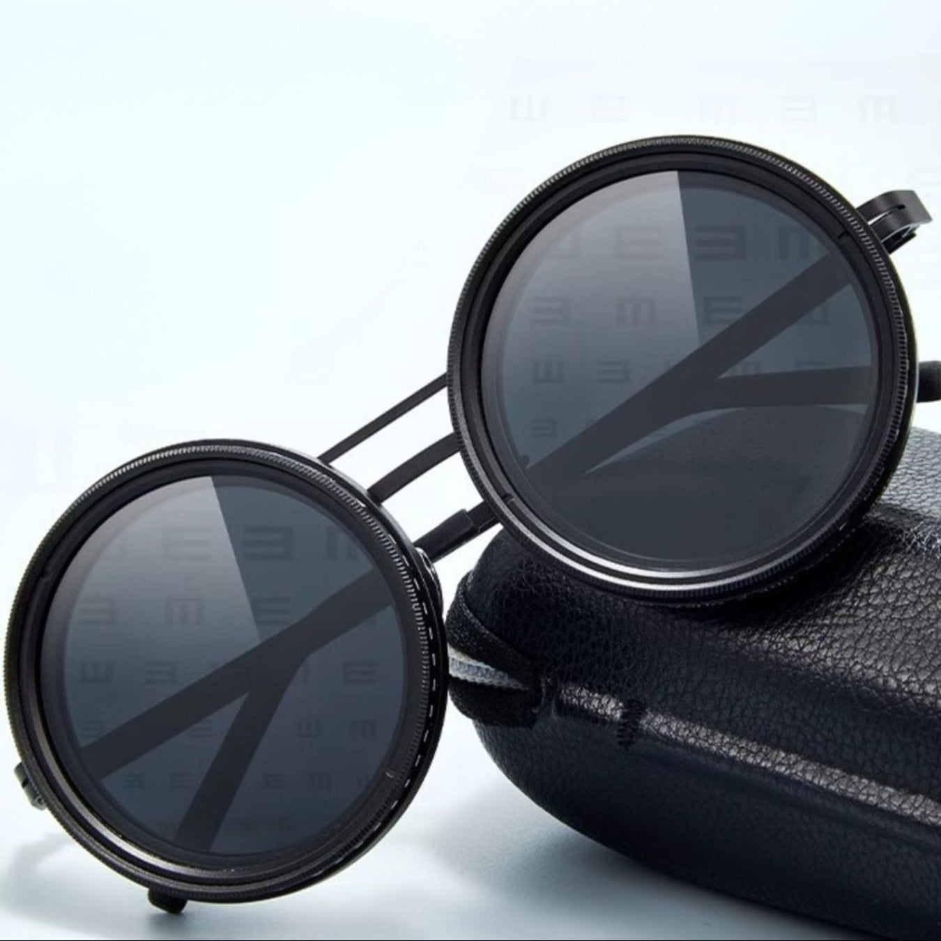 Fitlybuy black round polarized sunglasses with adjustable light reduction, resting on a premium black leather-style case.