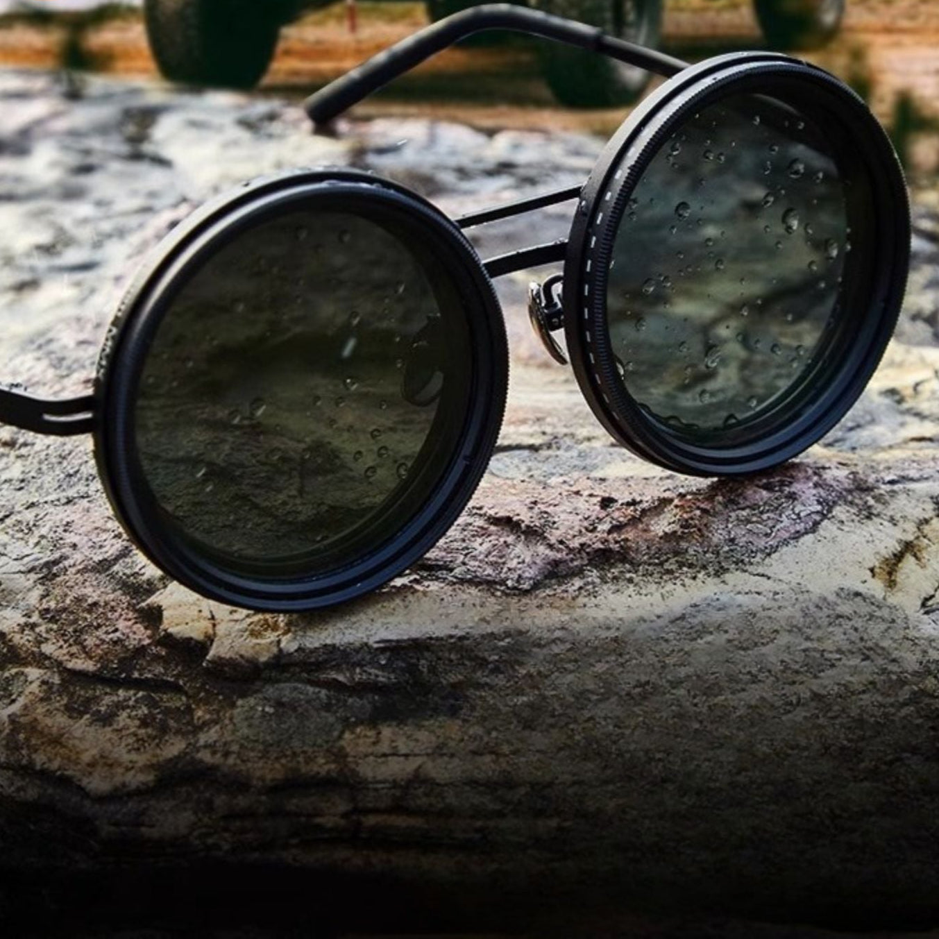 Fitlybuy unisex round polarized sunglasses with black metal frames and light-reducing lenses on a textured rock surface.