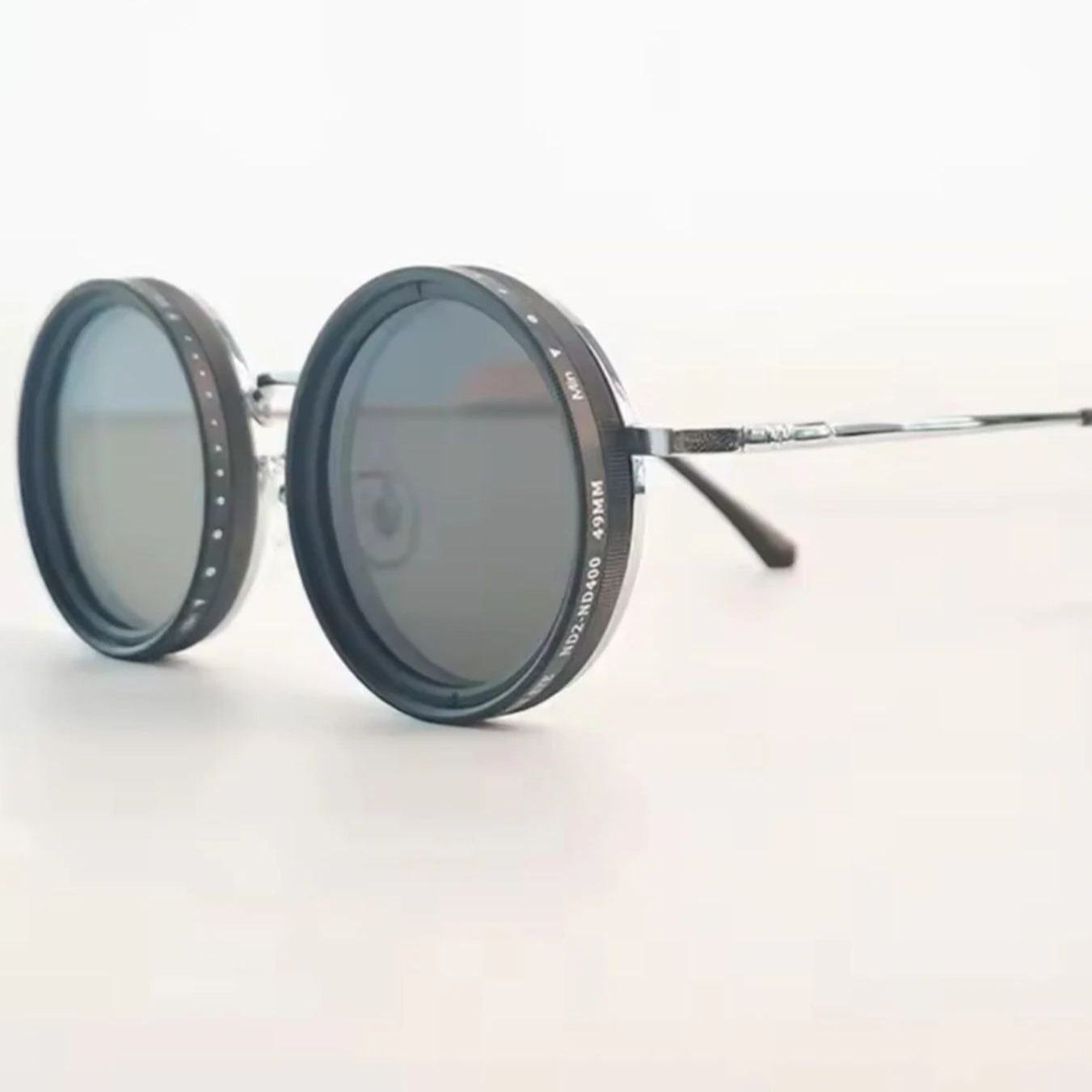 Fitlybuy round polarized sunglasses with metal frame and adjustable light-reduction lens dial on a white background.