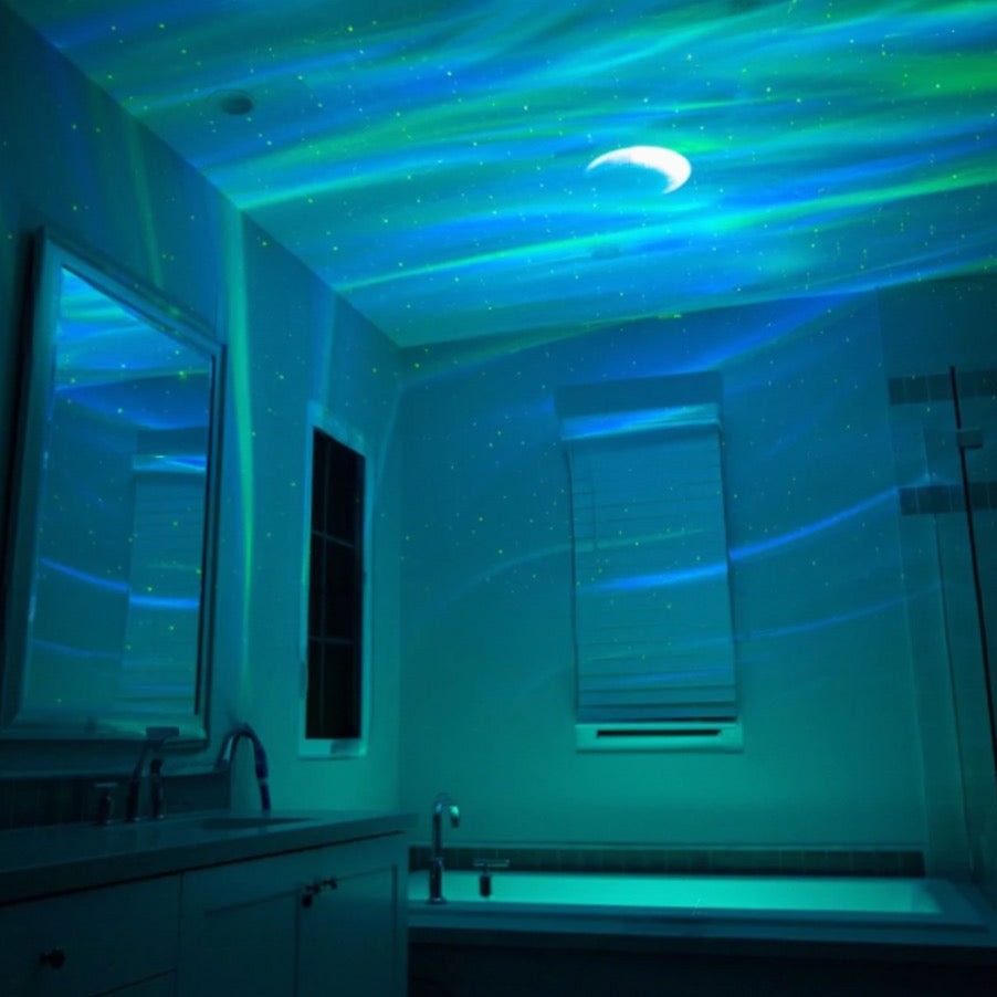 Fitlybuy Aurora projector lighting up a bathroom ceiling with blue and green northern lights and a crescent moon effect.