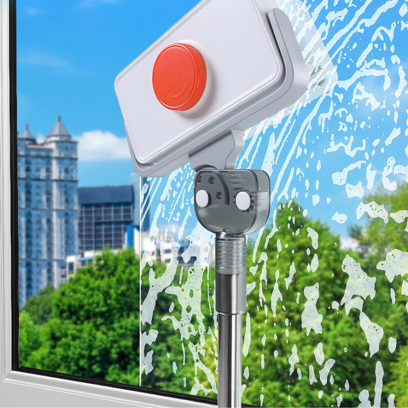 Fitlybuy magnetic window cleaner with extendable handle cleaning soapy glass, city view in background.