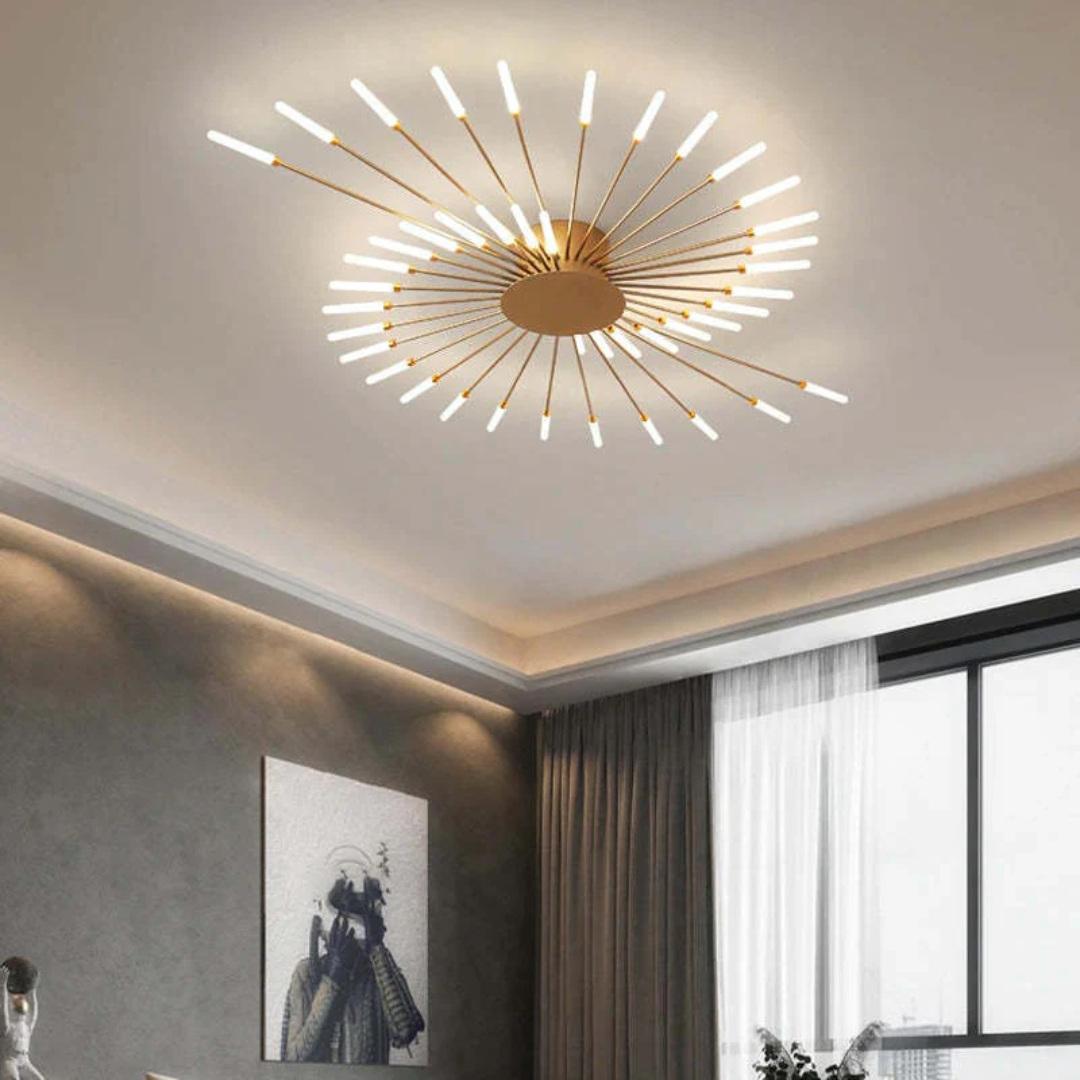 Modern gold LED ceiling light with starburst spiral design installed on a bedroom ceiling.