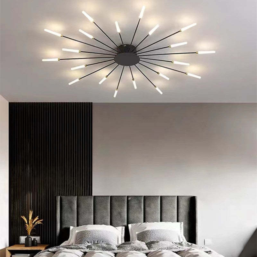 Fitlybuy modern black starburst LED ceiling light with glowing light-tipped stems installed in a contemporary bedroom.