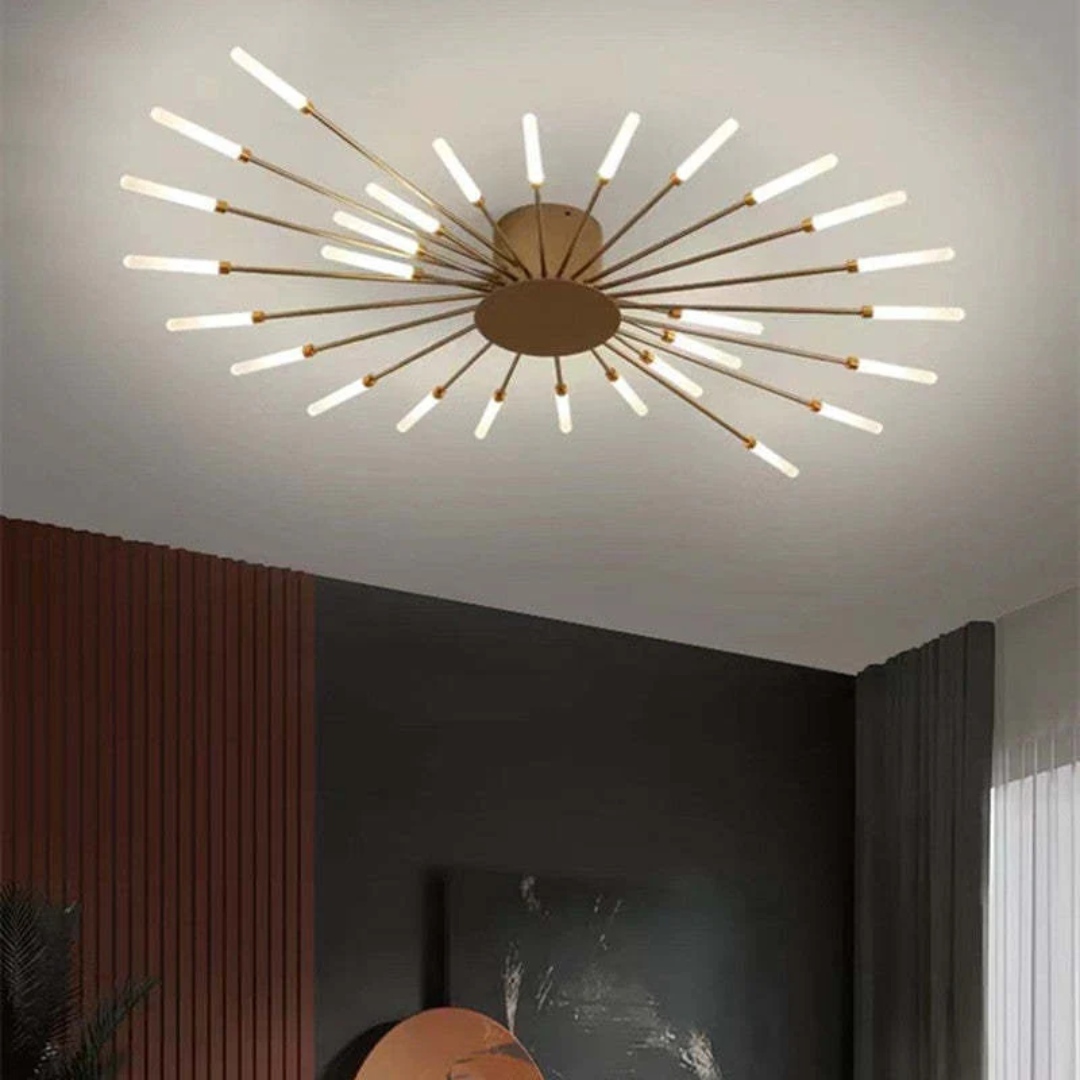 Modern gold starburst LED ceiling light with multiple radiating glowing arms installed in a contemporary living room.