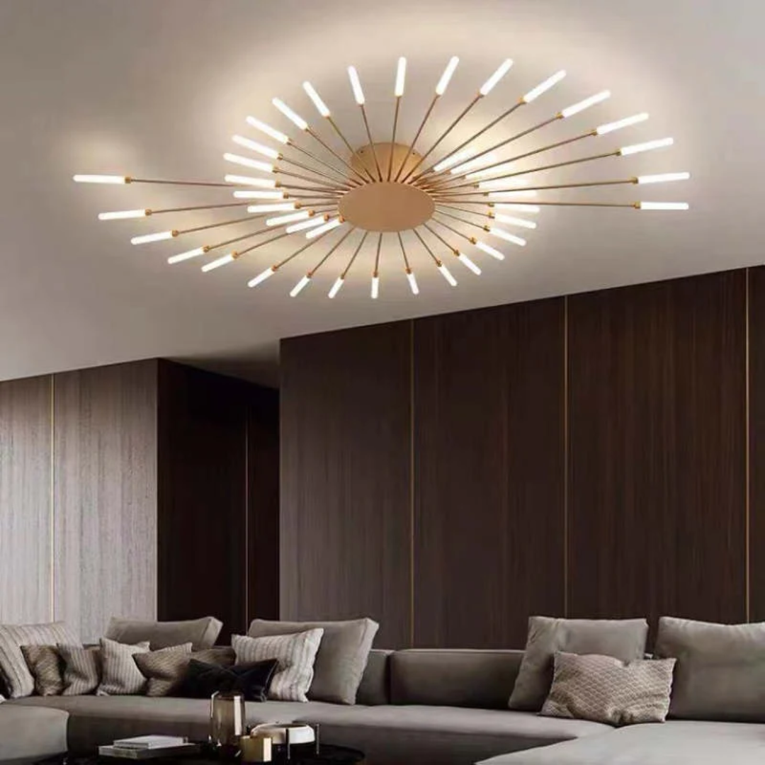 Modern gold sputnik LED ceiling light with radiant arms, mounted in a contemporary living room with a grey sofa.