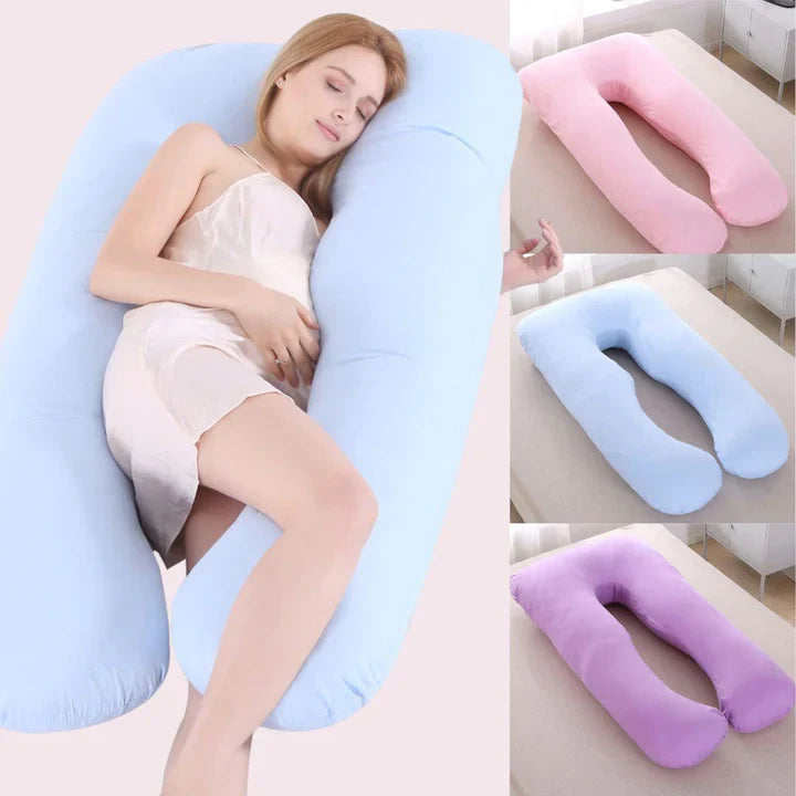 U-shaped pregnancy body pillow in blue, pink, and purple, shown with a pregnant woman resting comfortably on a bed.