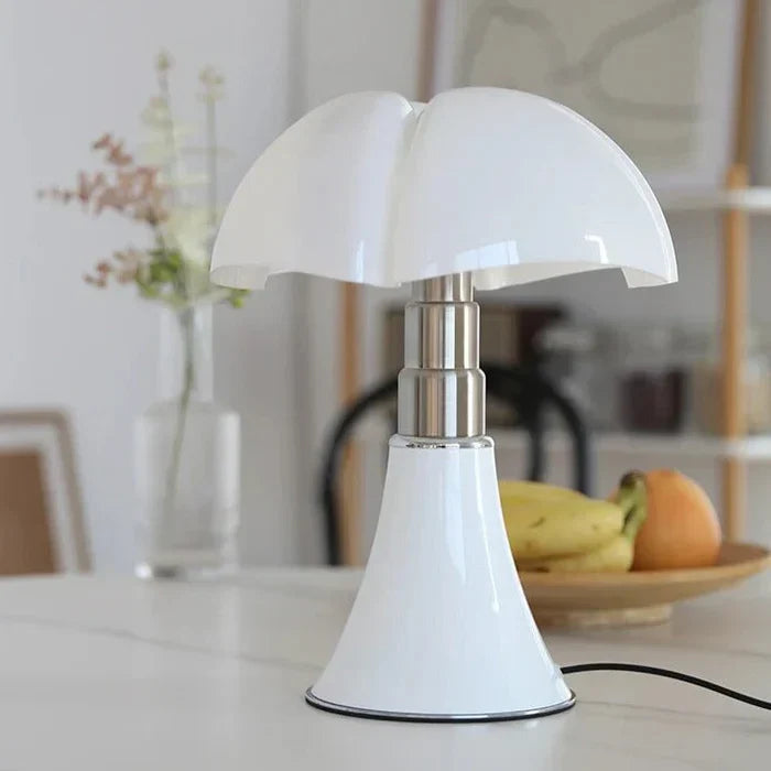 Fitlybuy FloraLuxe white mushroom-shaped table lamp with chrome stem on a table with fruit and decor in background.