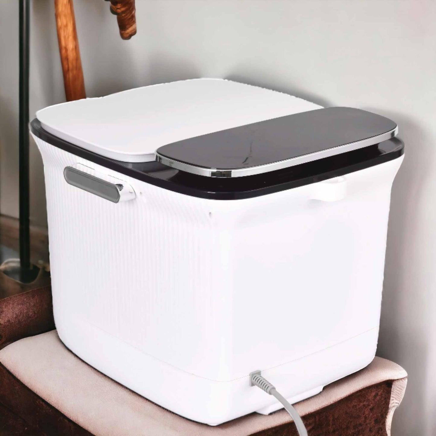 Fitlybuy white and black automatic heated foot spa massager with a digital control lid, resting on a cushioned stool.