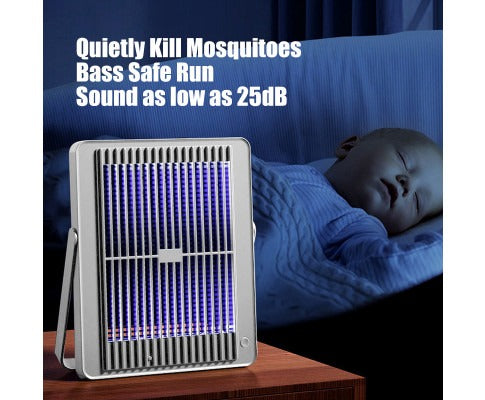 Fitlybuy silver electric insect killer with purple UV light on a bedside table near a sleeping baby.