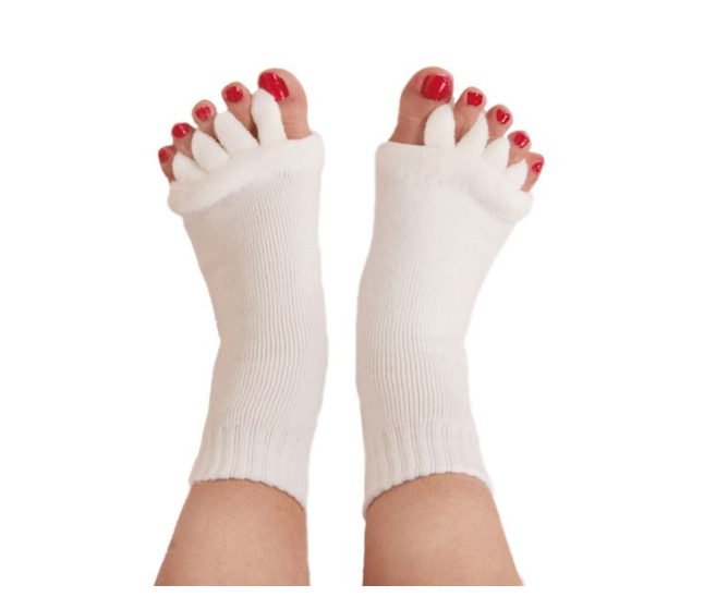 Fitlybuy white ComfortFlex toe separator socks worn on feet with red-painted toenails, isolated on a white background.