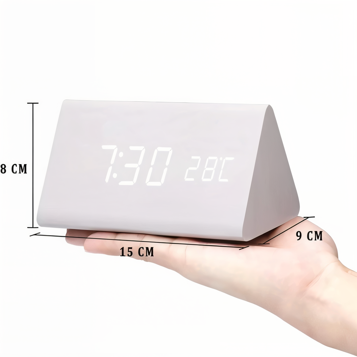 Triangular white wooden LED digital alarm clock showing time and temperature held in hand, dimensions 15x9x8 cm.