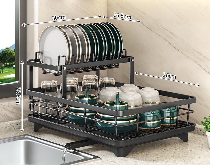 Black, two-tier adjustable dish drying rack with built-in drainer, holding plates, bowls, and glasses on a kitchen counter.