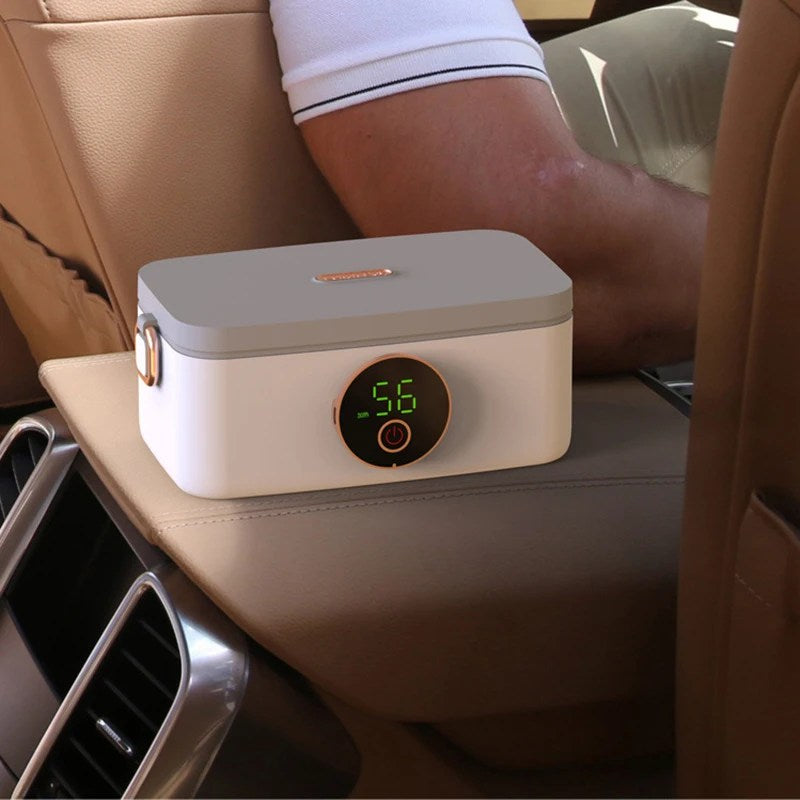 Fitlybuy HeatMate Pro portable heated lunchbox in white and grey on a car center console with digital temperature display.