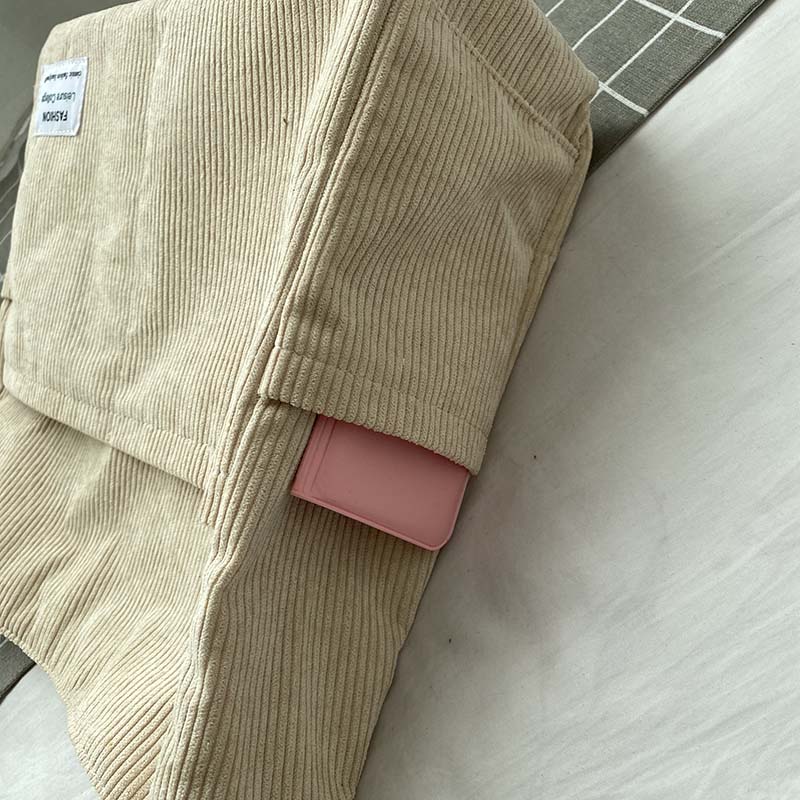 Beige corduroy Fitlybuy crossbody bag with a small rectangular patch label, featuring a pink card holder in the pocket.