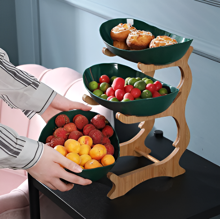 Fitlybuy 3-tier wooden fruit stand with dark green bowls, holding pastries, berries, and apricots on a black table.