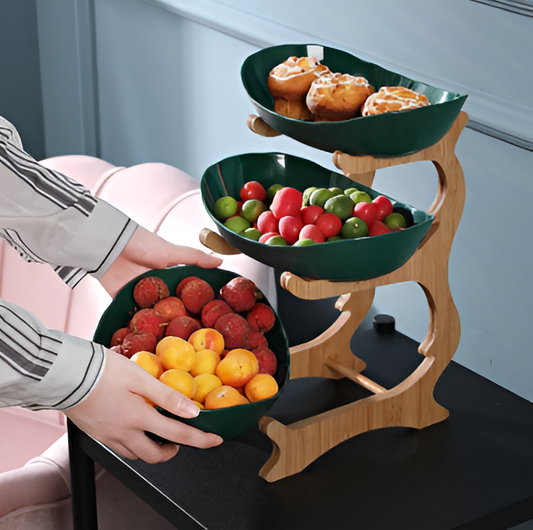 Fitlybuy 3-tier wooden fruit stand with dark green bowls, holding pastries, berries, and apricots on a black table.