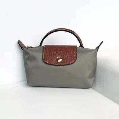 Fitlybuy Calo mini handbag in grey nylon with brown leather top handle, flap closure, and gold-tone hardware.