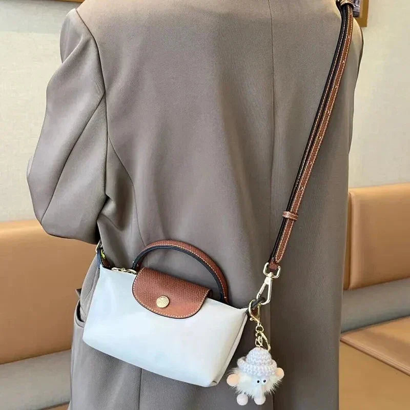 Fitlybuy Calo mini handbag in white and brown with a top handle, shoulder strap, and cute sheep keychain accessory.