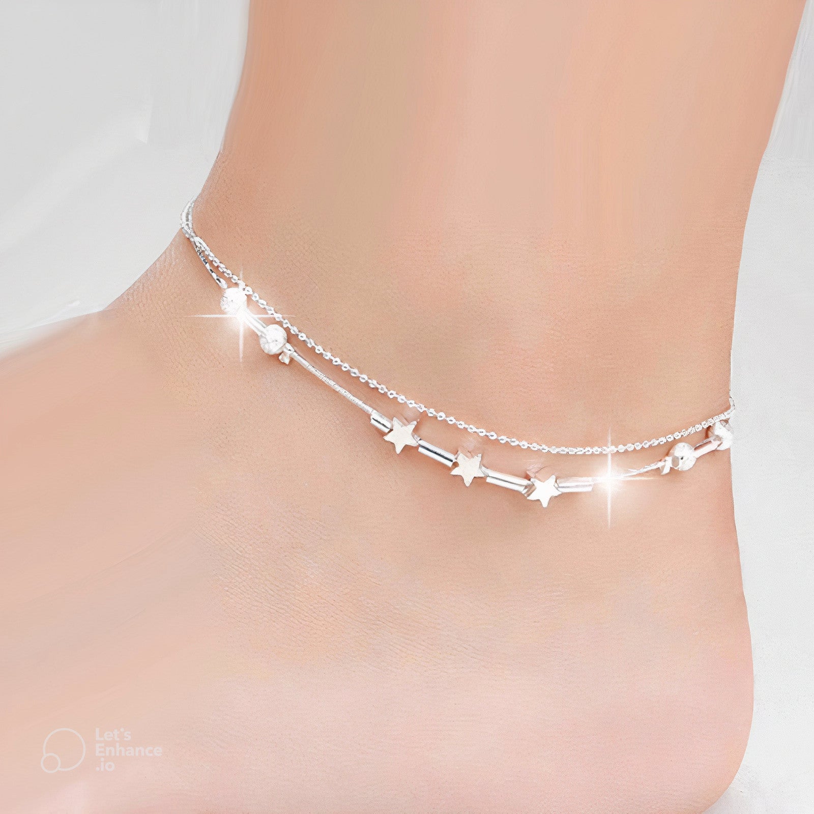 Fitlybuy Sophie silver double-chain anklet with star charms and adjustable clasp worn on an ankle.