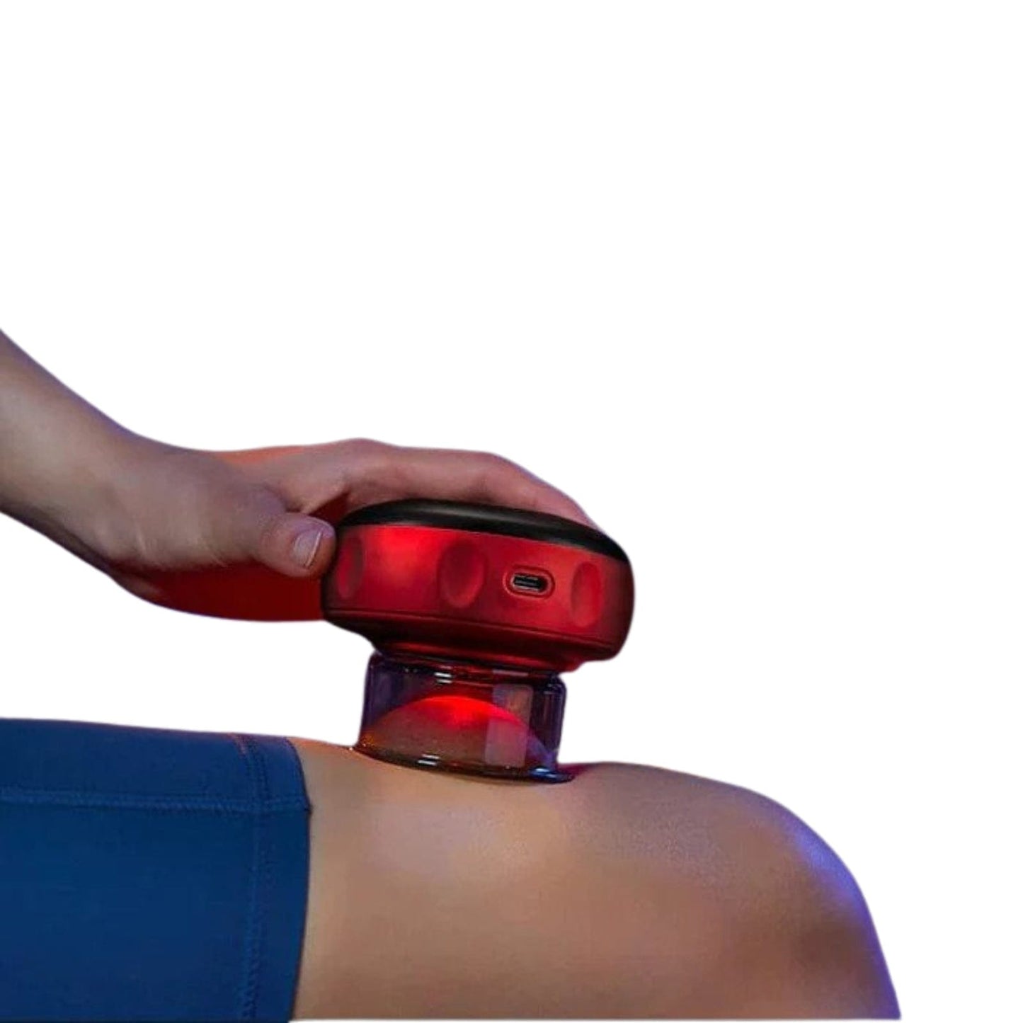 Hand holding a red Fitlybuy electric vacuum cupping massager with red light therapy against a person's thigh.