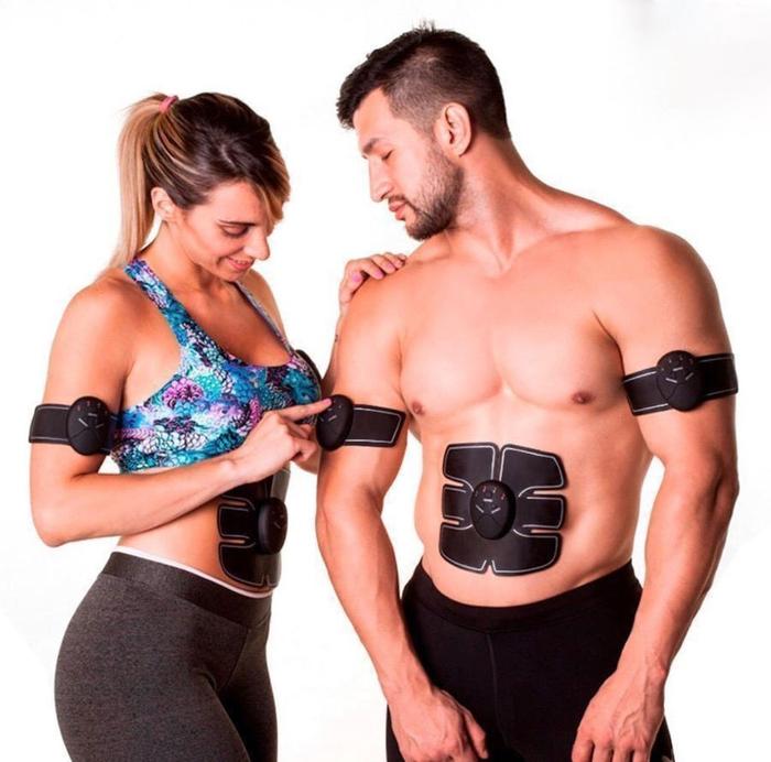 Fitlybuy black EMS muscle stimulator patches on the abs and arms of a fitness-focused man and woman.