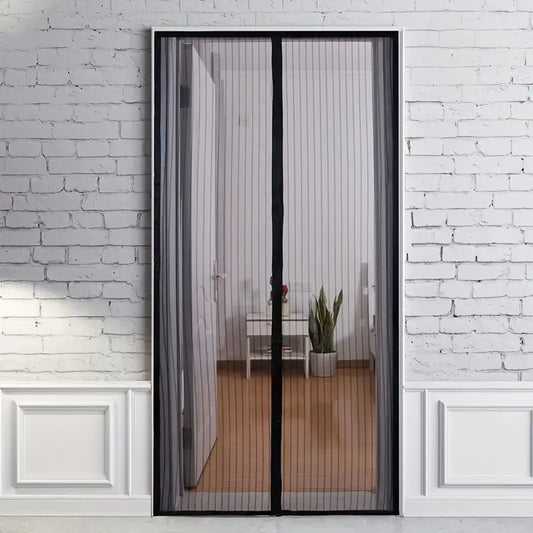 Black Fitlybuy BugGuard magnetic mesh fly screen door installed on a white door frame against a white brick wall.