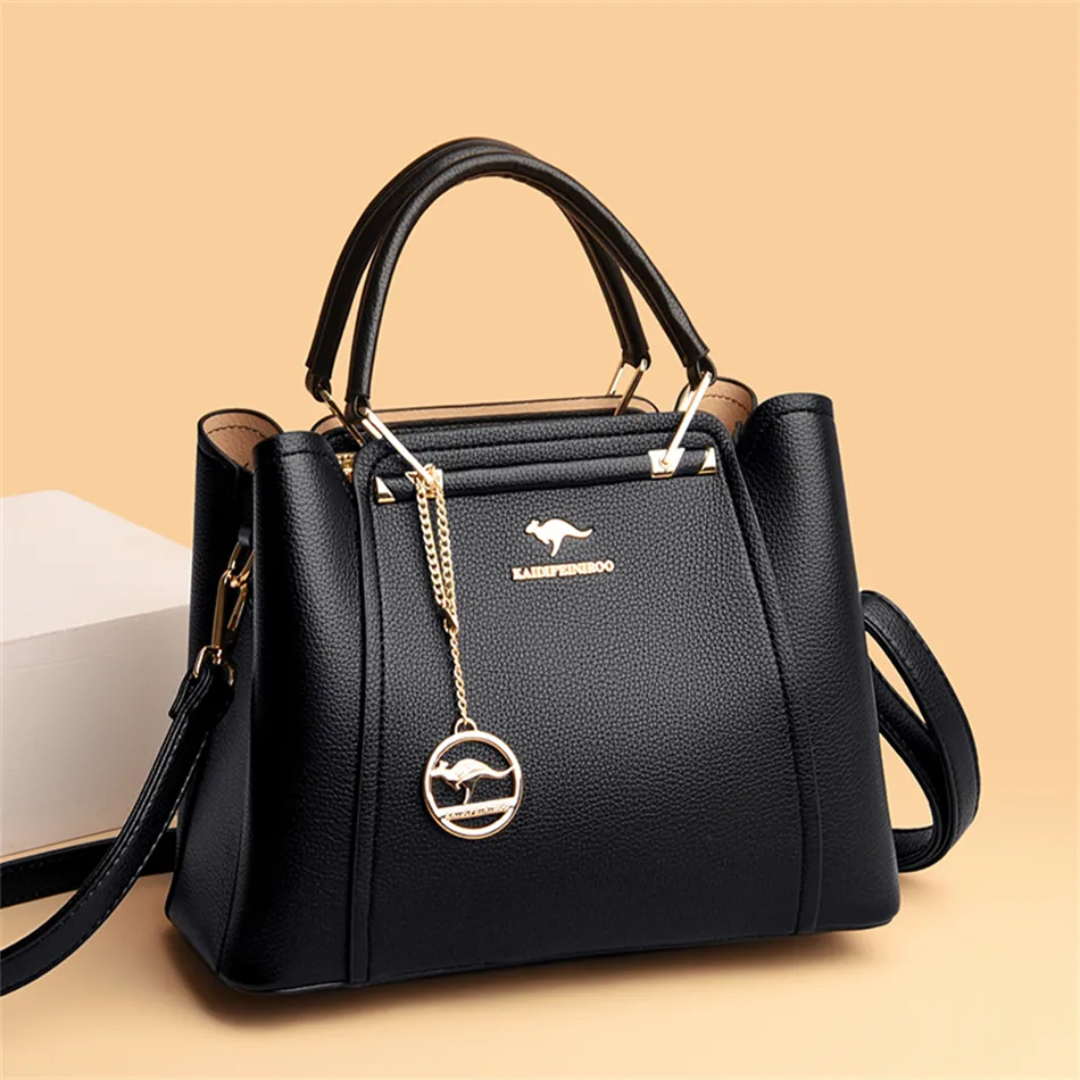 Black PU leather Fitlybuy Vivian shoulder bag with gold hardware, chain charm, and adjustable crossbody strap.