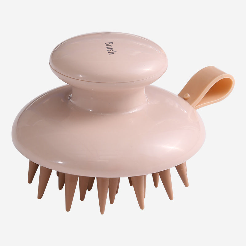 Fitlybuy Scalp Bliss Pro: light pink scalp massager with ergonomic handle, loop strap, and flexible silicone bristles.