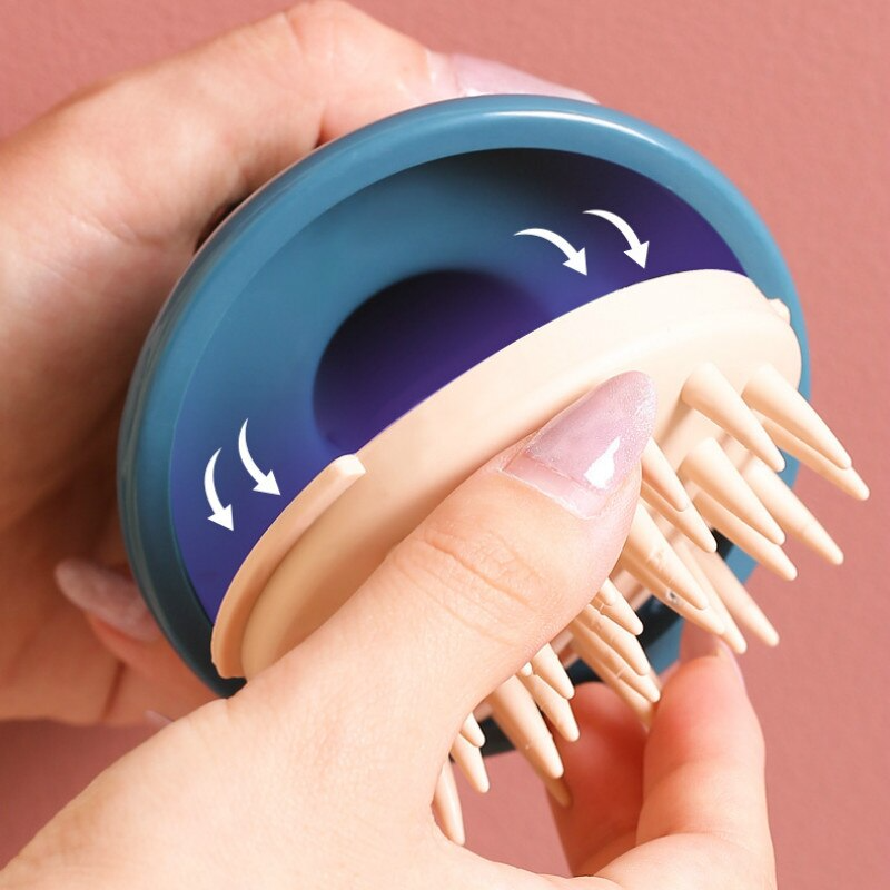 Hands holding a blue and beige Fitlybuy Scalp Bliss Pro massager with silicone bristles and ergonomic grip design.