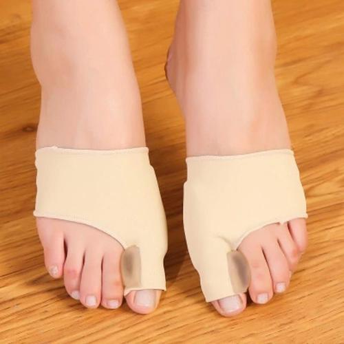 Fitlybuy pair of beige fabric bunion correctors with silicone toe separators worn on feet over a wooden floor.