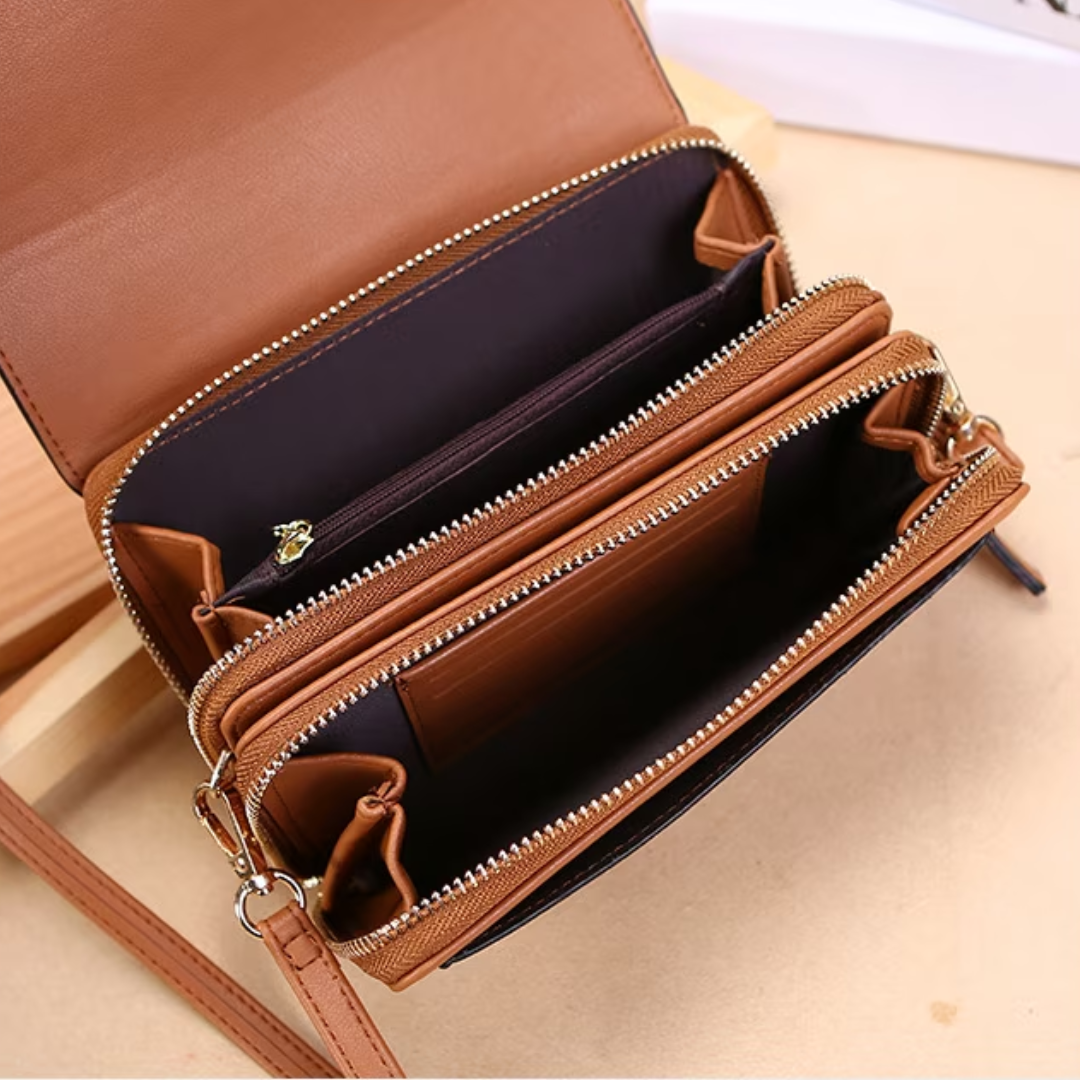 Tan leather crossbody bag featuring multiple zipped compartments and interior card slots, shown open on a neutral surface.