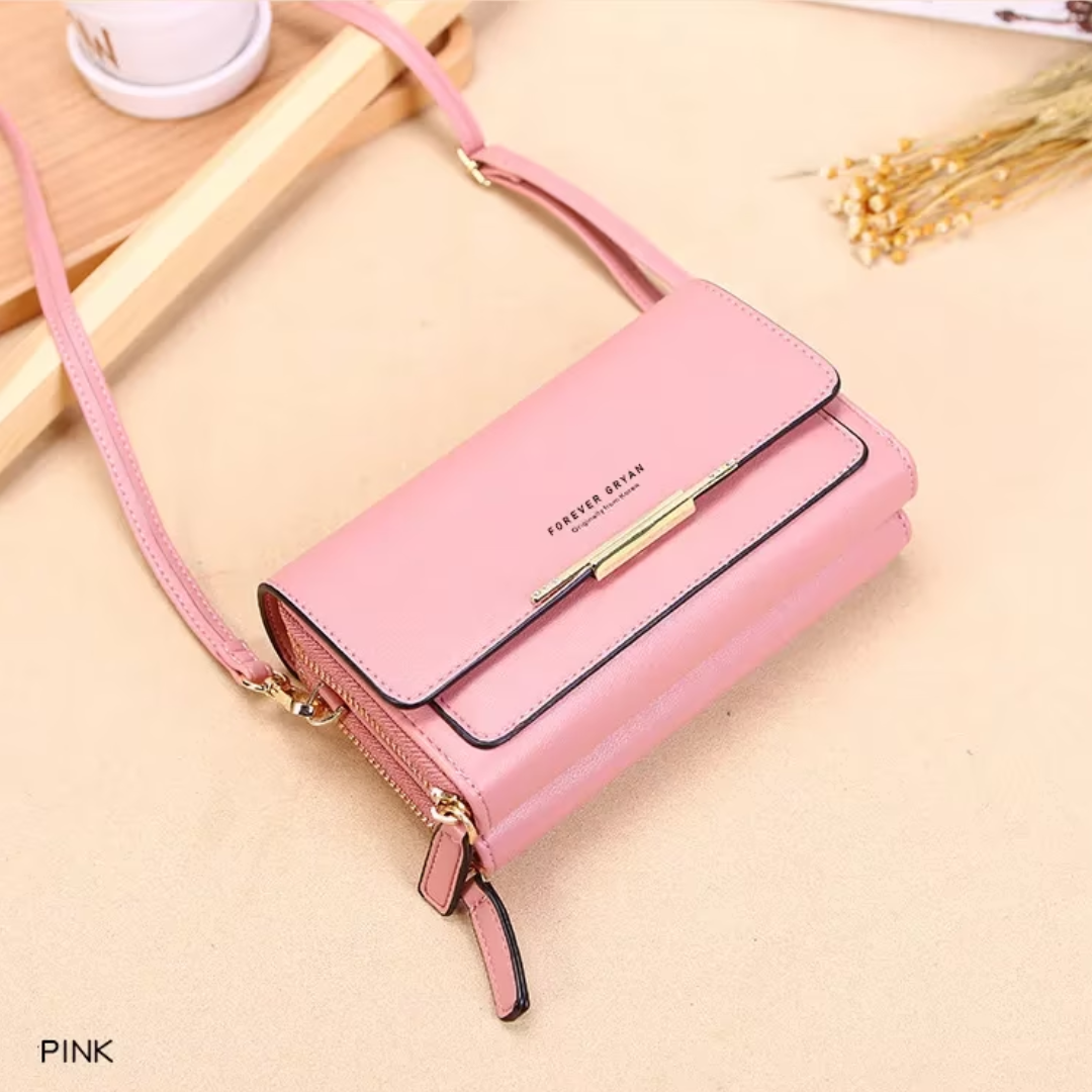 Pink Fitlybuy leather crossbody bag with gold-tone hardware, a flap closure, and zippered compartments.