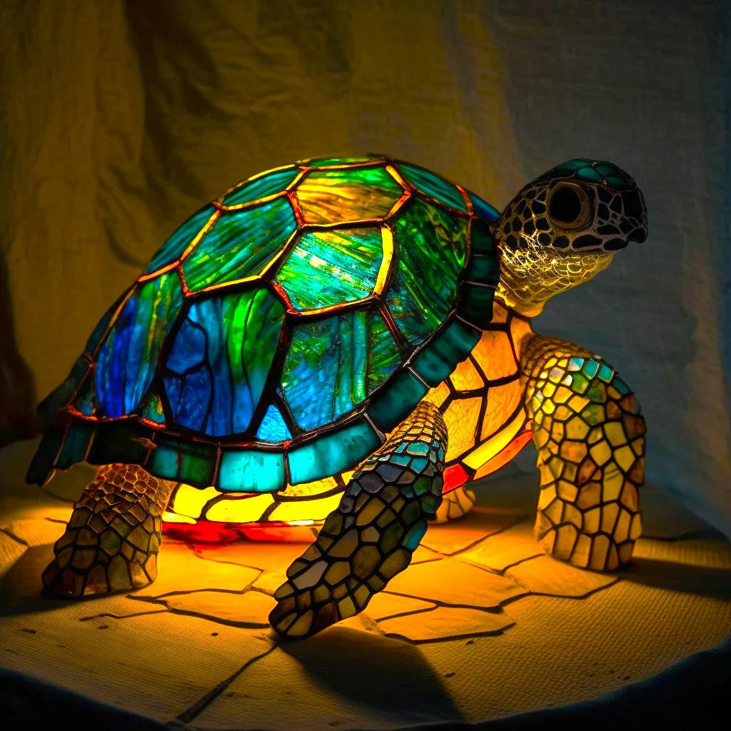 Stained glass turtle lamp with blue and green shell glowing with warm yellow ambient light on a neutral background.