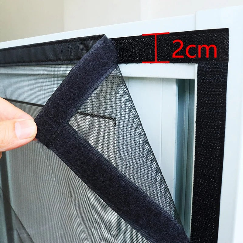 Fitlybuy BugGuard black mesh screen with 2cm wide Velcro adhesive strip installation on a white door frame.