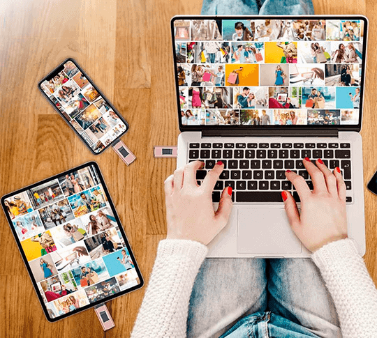 Fitlybuy rose gold PhoneStick backup drive connected to a phone, tablet, and laptop showing photo gallery grids.
