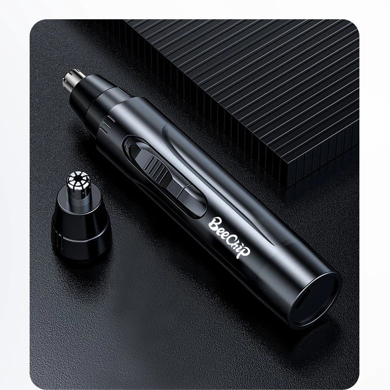 Matte black rechargeable nose and ear hair trimmer with precision grooming head, set on a textured black surface.