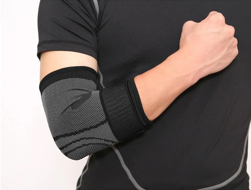 Fitlybuy grey and black knit elbow compression sleeve with adjustable strap on a person wearing a black athletic shirt.