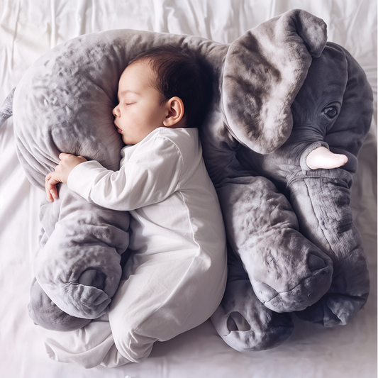 Baby sleeping on a soft, grey Fitlybuy plush elephant pillow. Comfortable, large, and ideal for cuddling.
