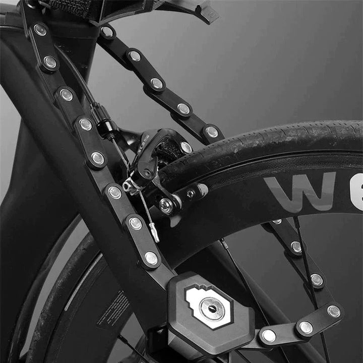Fitlybuy black heavy-duty foldable anti-theft bike lock mounted securely on a bicycle frame against a gray background.