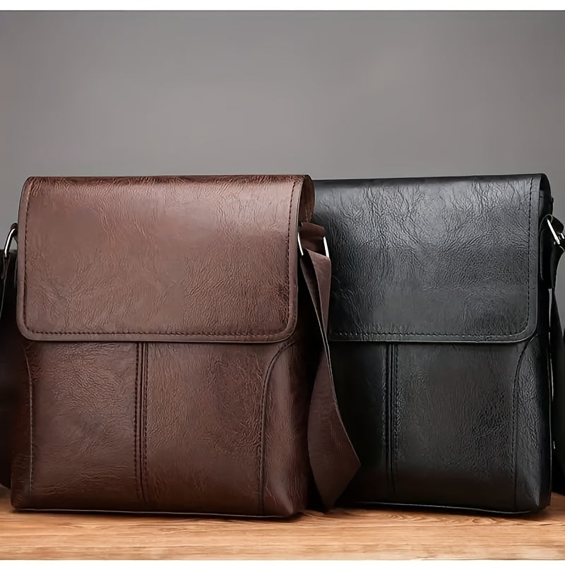 Two vintage-style brown and black PU leather shoulder bags with flap covers and adjustable straps on a wooden surface.