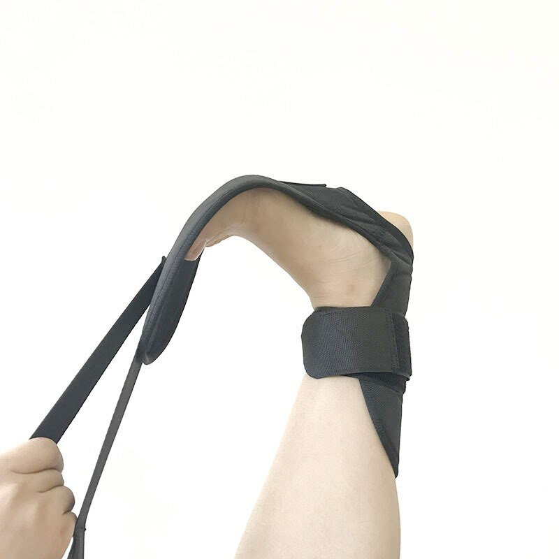 Fitlybuy black leg stretcher on a foot, with a hand pulling the strap to provide a deep calf and fascia stretch.