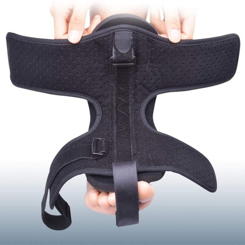 Fitlybuy black orthopedic foot and ankle splint with ComfortFlex adjustable straps, held by hands against a white background.