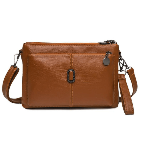 Fitlybuy Fosh small tan leather shoulder bag with premium finish, zip closure, and a central decorative metal emblem.