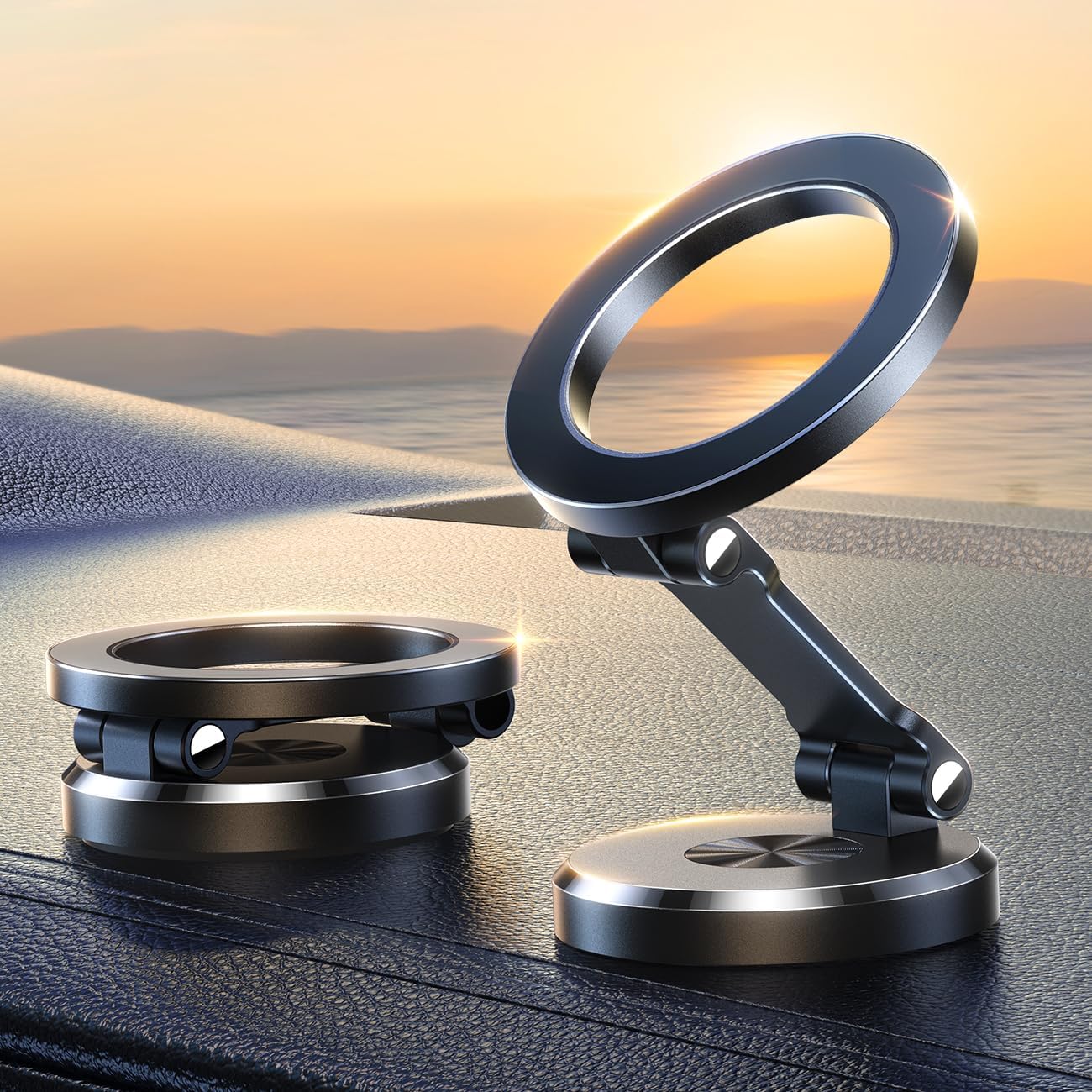 Two black, foldable Fitlybuy magnetic car phone holders on a dashboard against a sunset, showing 360-degree adjustability.