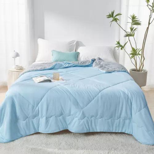 Fitlybuy Aussie Cool Ice Sleep Blanket in light blue, featuring ChillTech cooling fabric on a cozy bedroom bed.