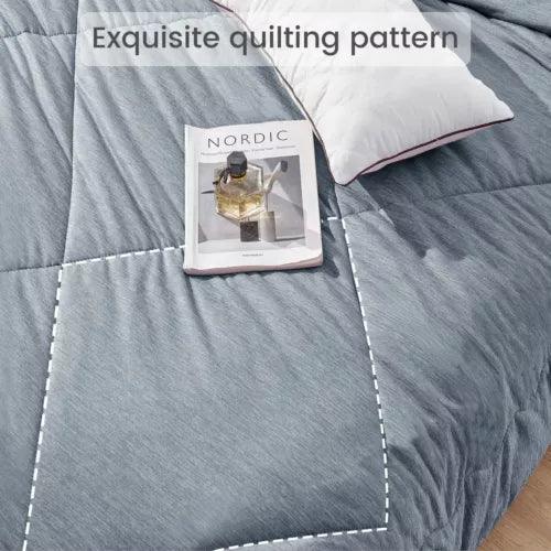Blue Fitlybuy Aussie Cool Ice cooling blanket with ChillTech fabric, featuring a quilted pattern and a magazine on top.