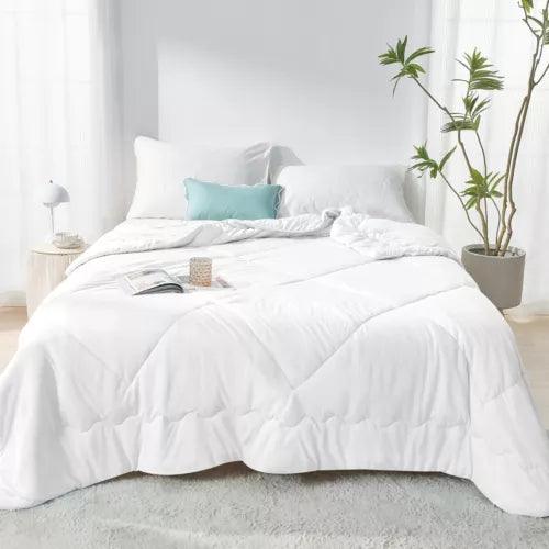 Fitlybuy Aussie Cool Ice white cooling blanket with ChillTech fabric on a made bed in a bright, modern bedroom.