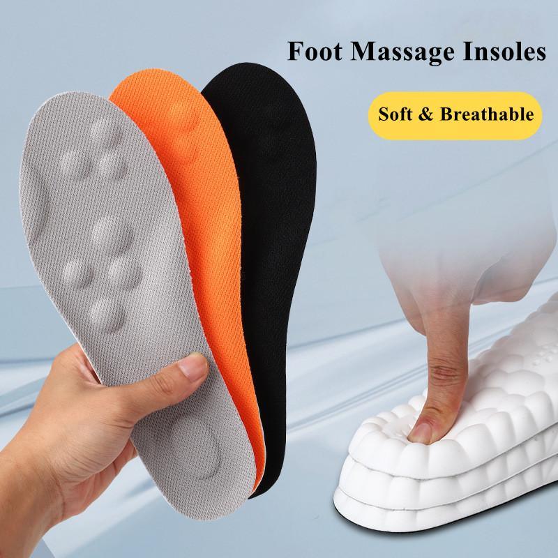 Fitlybuy AirCloud massage insoles in grey, orange, and black, shown being pressed to highlight soft, cushioned texture.