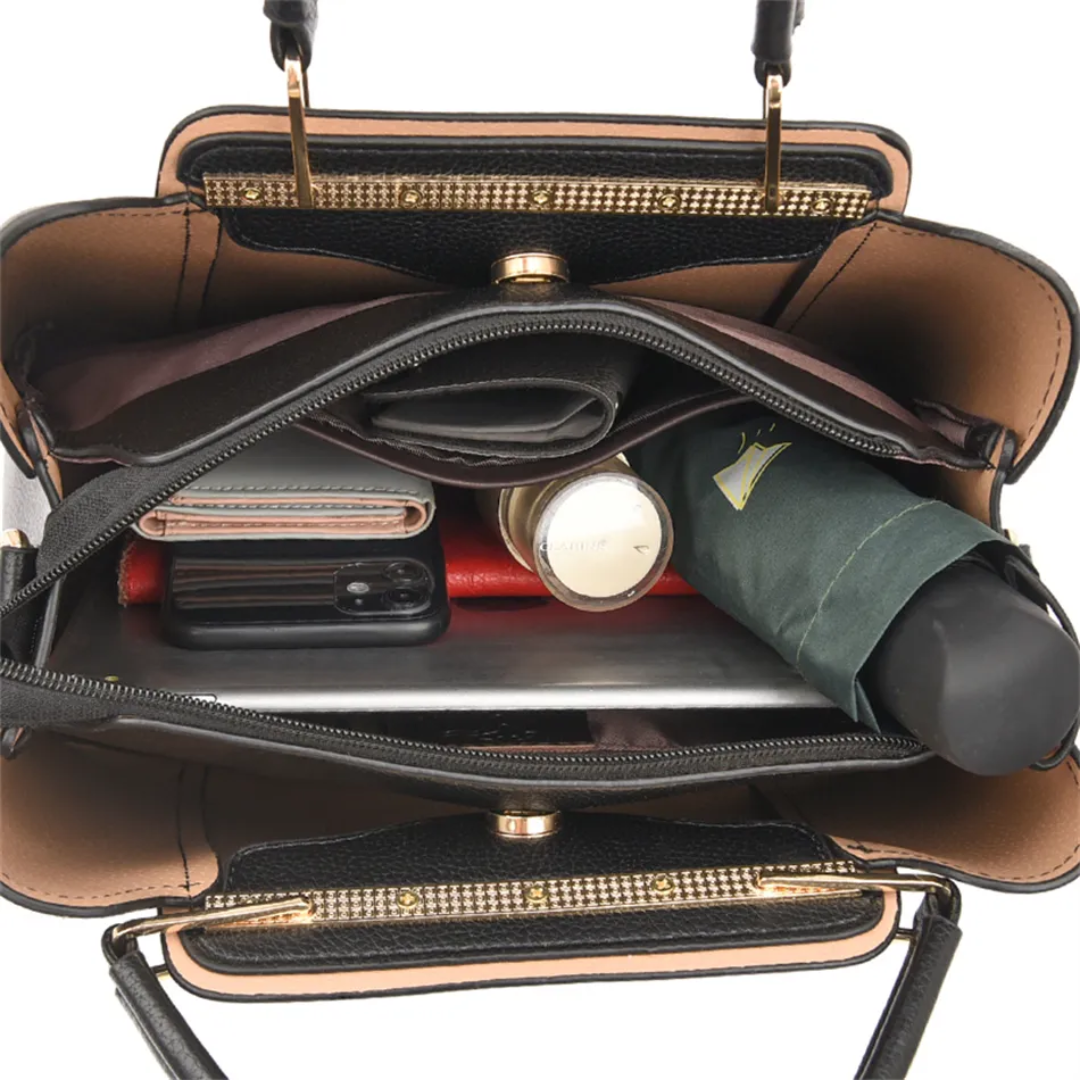 Interior view of a black PU leather Fitlybuy Vivian shoulder bag filled with a phone, wallet, cosmetics, and umbrella.